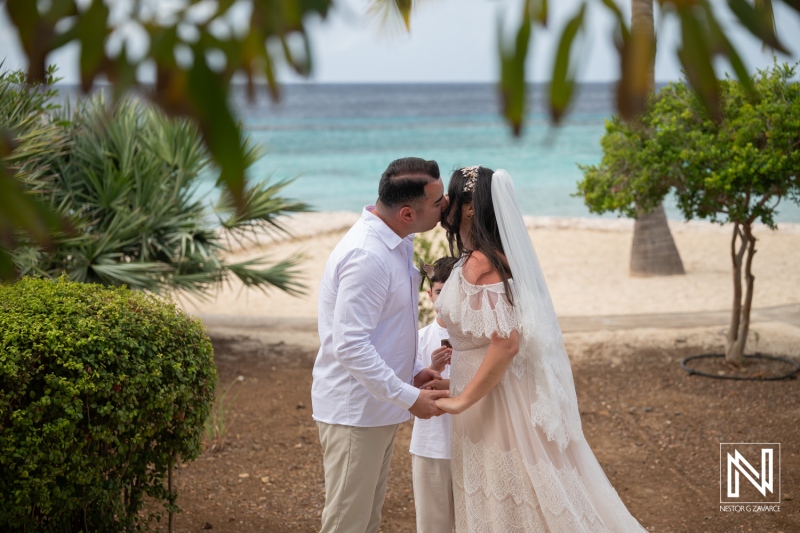 Couple shares a kiss during vow renewal ceremony at Curacao Marriott Beach Resort