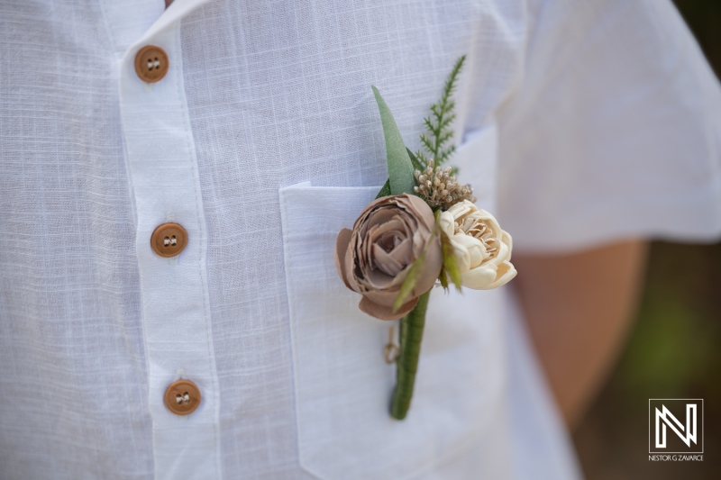 Vow renewal ceremony at Curacao Marriott Beach Resort includes floral details on attire