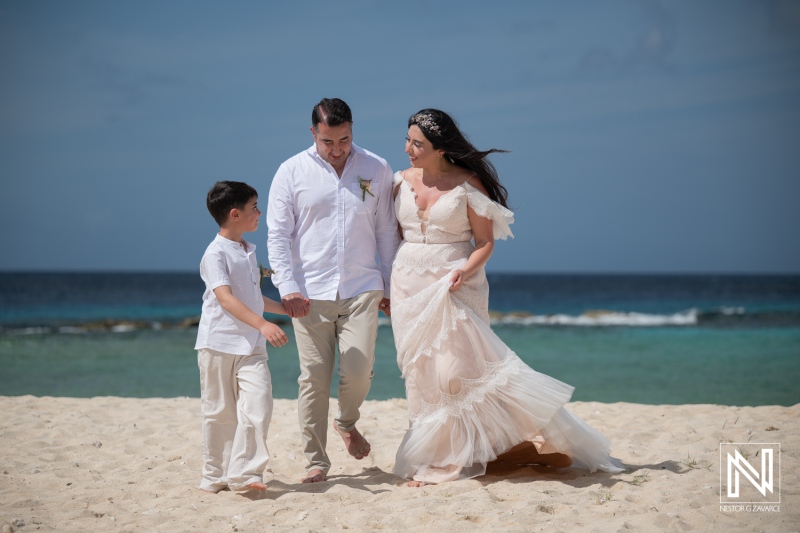 Couple and child enjoy vow renewal on the beach at Curacao Marriott Beach Resort