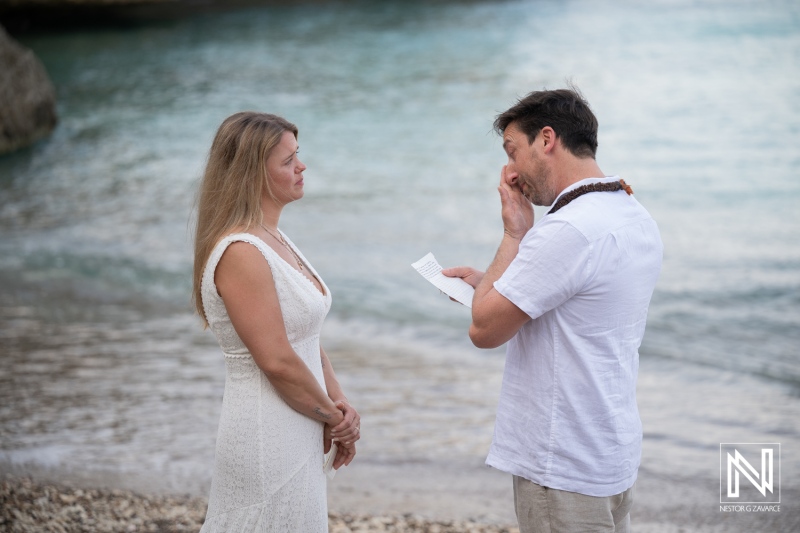 Vow renewal ceremony at Playa Jeremi in Curacao during sunset with couple exchanging promises