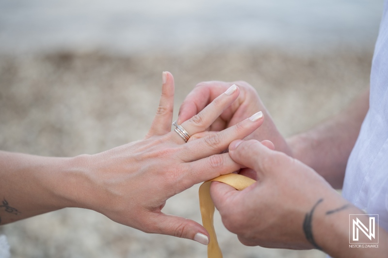 Vow renewal ceremony at Playa Jeremi with couple exchanging rings on the beach
