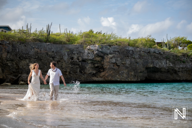 Couple celebrates vow renewal at Playa Jeremi in Curacao with waves and sand