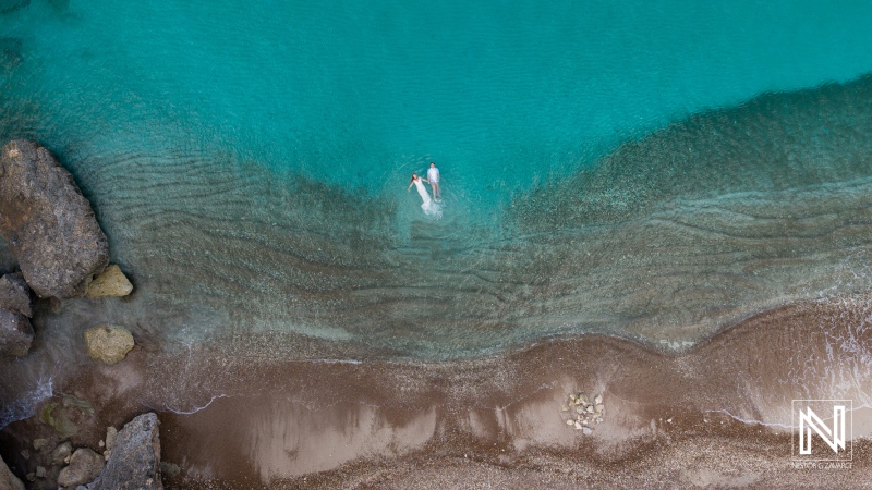 Vow renewal ceremony at Playa Jeremi in Curacao takes place in the clear blue water under the sun