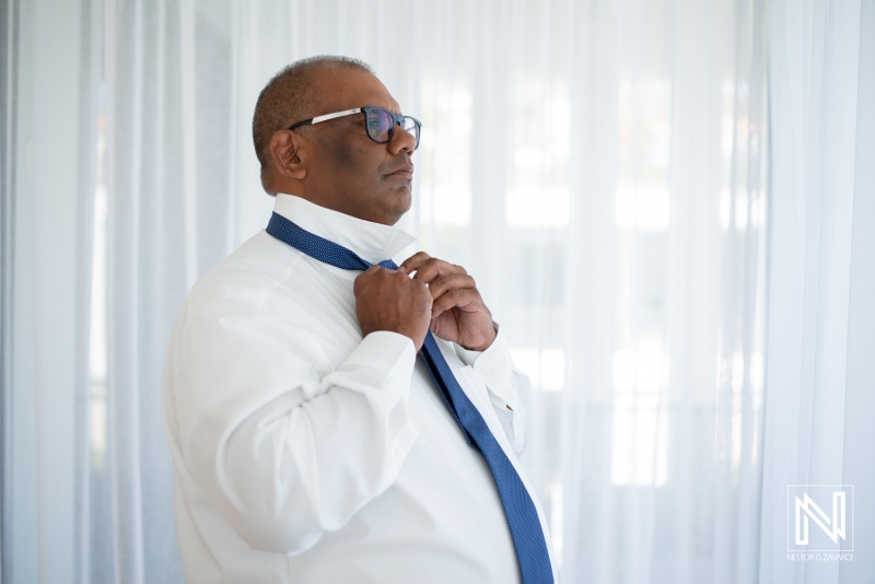 Groom getting into attire