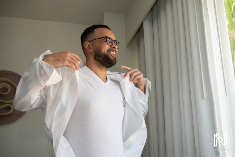 Groom getting into attire