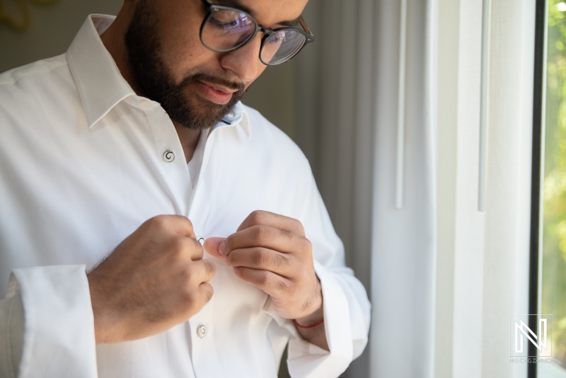 Groom getting into attire