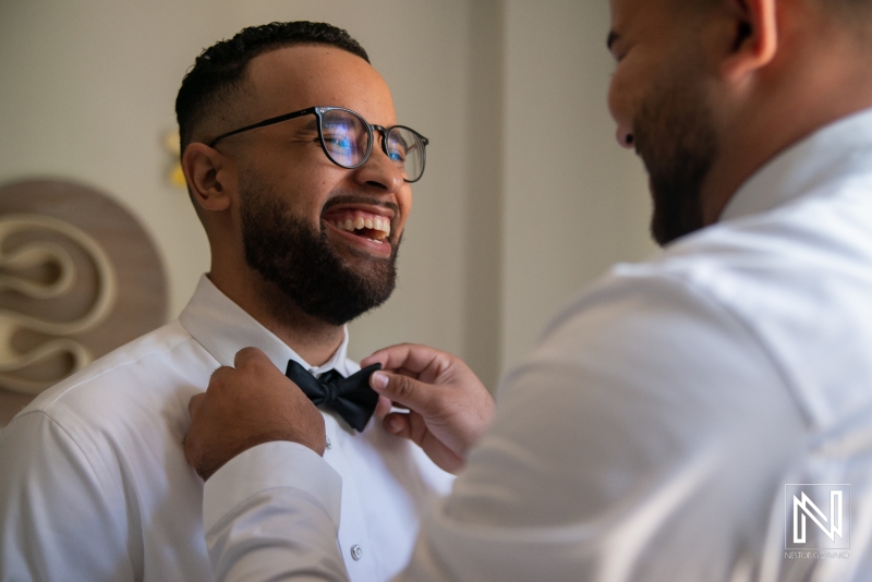Groom getting into attire