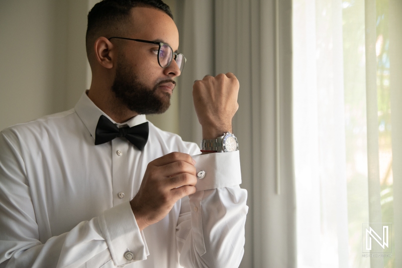 Groom getting into attire