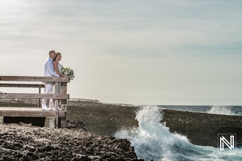 Bride and groom posing in Shete Boka National Park balcony