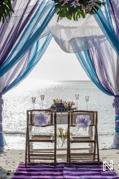 Beach wedding gazebo decoration with purple and blue