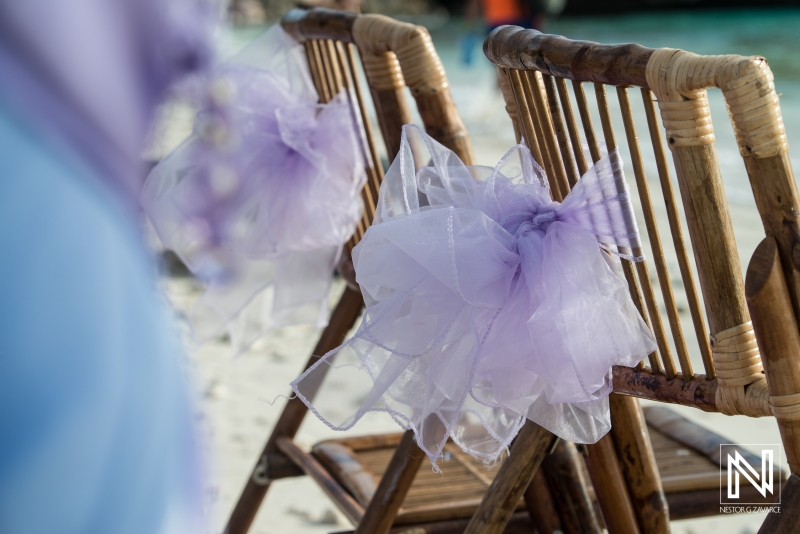 Beach wedding chairs decoration with purple and blue