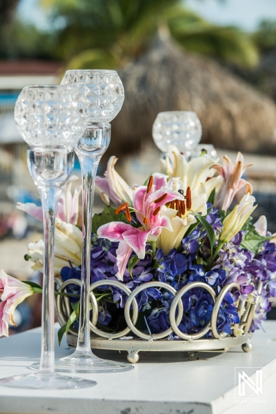 Candle holders decoration with flowers on the beach