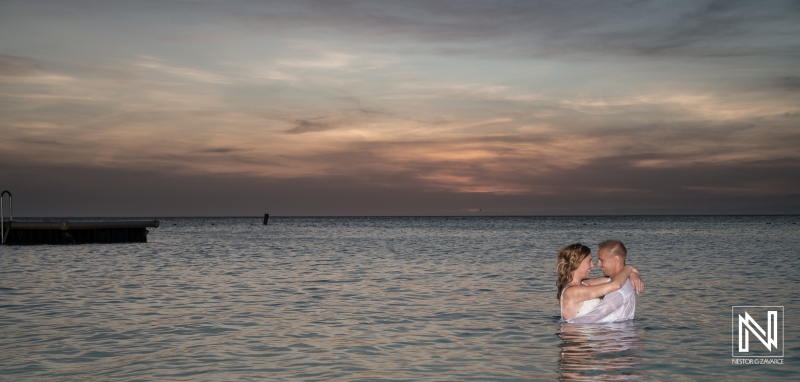Wedding trash the dress at Kenepa Grandi Beach Curacao Bride and Groom hugging each other on the water