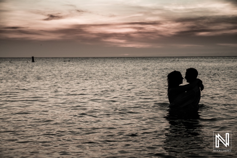 Wedding trash the dress at Kenepa Grandi Beach Curacao bride and groom hugging each other on the water