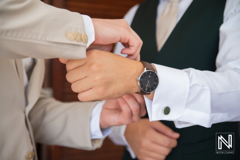 Groom getting into attire