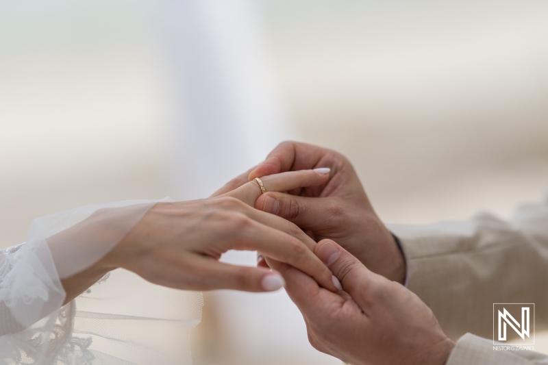 Couple Exchanging Wedding Rings on a Serene Beach During a Romantic Sunset Ceremony, Capturing a Moment of Love and Commitment on a Picturesque Day