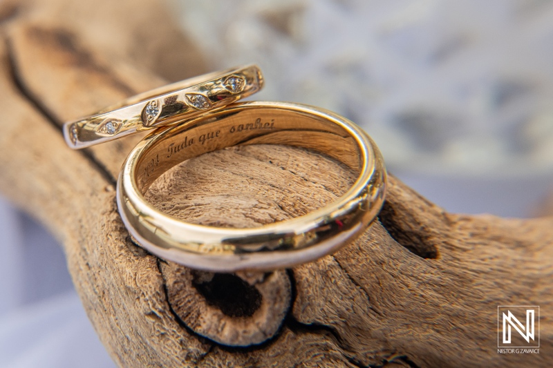 Elegant Gold Wedding Rings Resting on a Wooden Surface, Showcasing Intricate Designs and Engravings, Perfect for Symbolizing Love and Commitment During a Ceremony