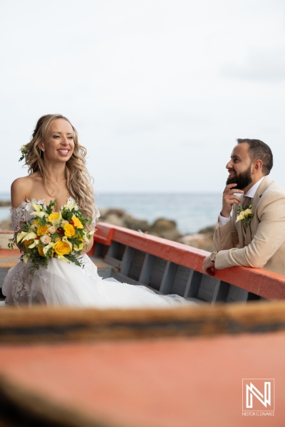 A Joyous Couple Enjoys Their Wedding Day With a Scenic Coastal Backdrop While Embracing Love and Happiness