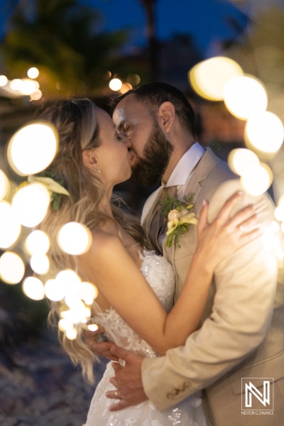 A Couple Shares a Romantic Kiss During Their Enchanting Wedding Celebration Adorned With Dreamy Fairy Lights in a Picturesque Outdoor Setting at Dusk