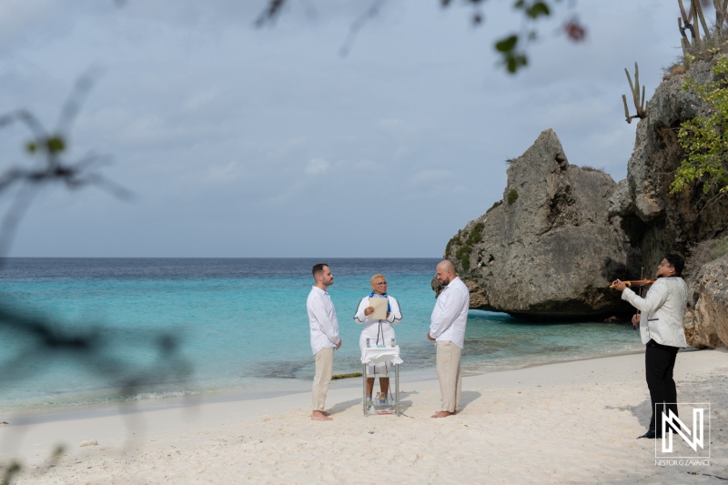 LGBT wedding celebration at sunrise on Cas Abao Beach, Curacao with a stunning backdrop of turquoise waters and rocky cliffs