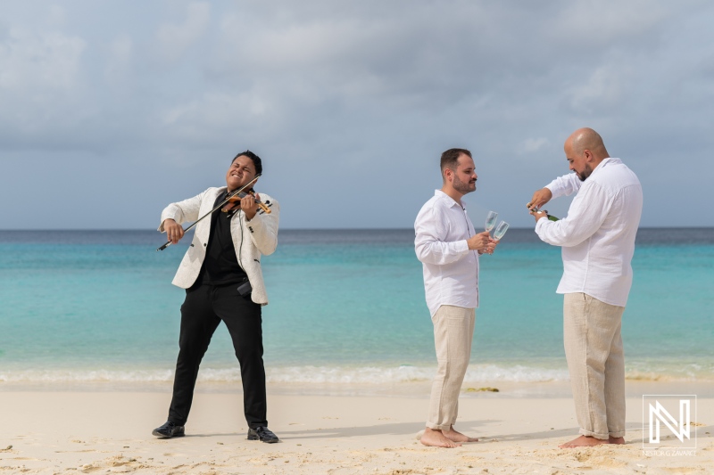 Celebration of love during an LGBT wedding ceremony at sunrise on Cas Abao Beach in Curacao, featuring music and toasts