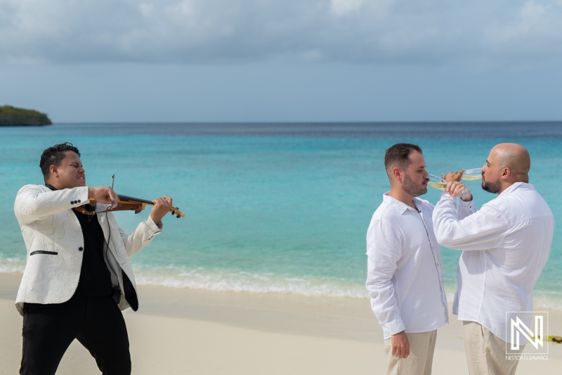 LGBT wedding celebration at sunrise on Cas Abao Beach, Curacao with music and love shared between two grooms