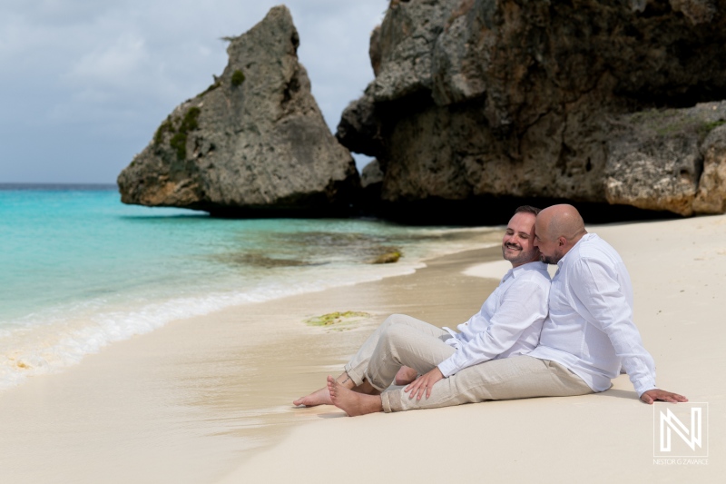 Two grooms celebrate love during a beautiful sunrise wedding at Cas Abao Beach in Curacao, showcasing an intimate moment by the ocean