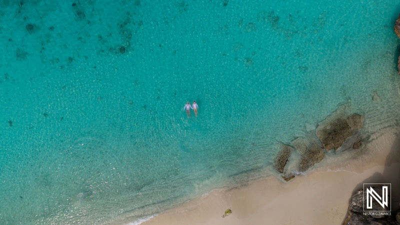 LGBT wedding celebration at sunrise on Cas Abao Beach in Curacao with stunning turquoise waters and soft sandy shores