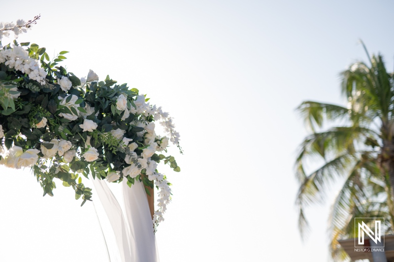 Beautiful wedding setup at Coral Estate Luxury Resort in Curacao with floral arch and tropical backdrop
