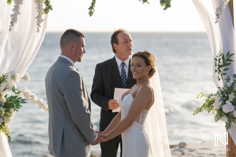 Wedding ceremony at Coral Estate Luxury Resort in Curacao with a stunning ocean backdrop and a joyful couple exchanging vows