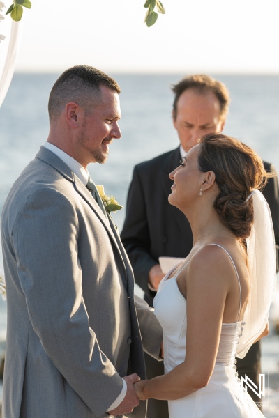 Wedding ceremony at Coral Estate Luxury Resort in Curacao with stunning ocean backdrop and emotional vows exchanged