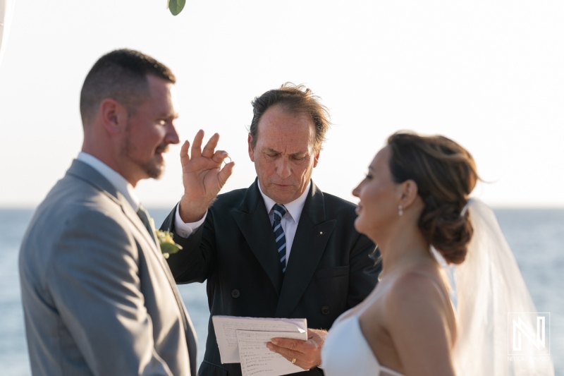 Wedding ceremony at Coral Estate Luxury Resort in Curacao captures intimate vows against serene ocean backdrop