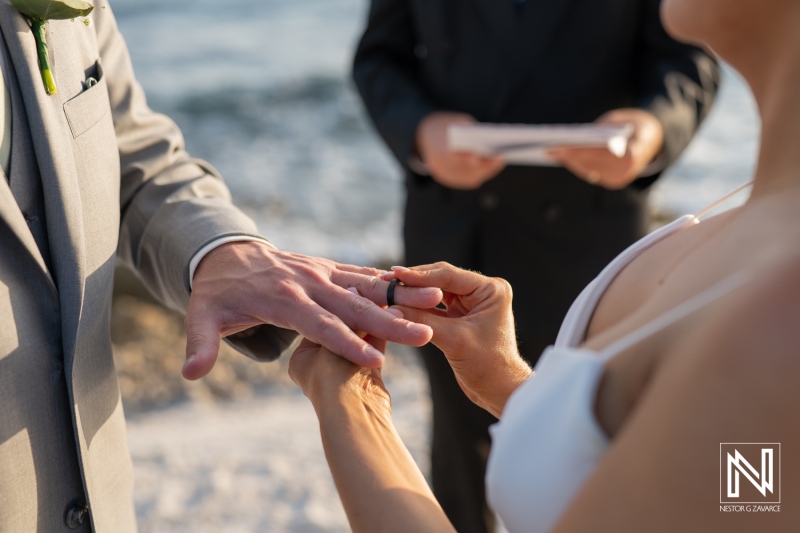 Couple exchanges wedding rings during ceremony at Coral Estate Luxury Resort in Curacao