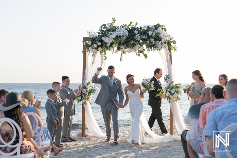 Couple celebrates wedding ceremony at Coral Estate Luxury Resort in Curacao during sunset with family and friends