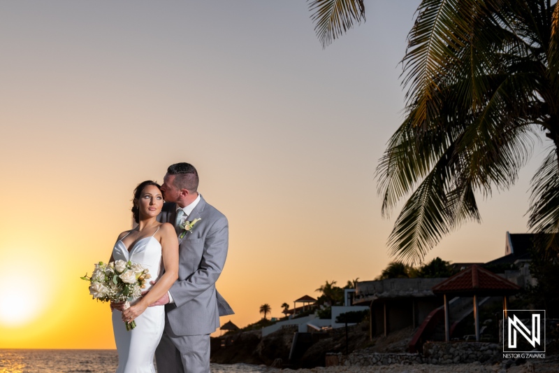 Couple celebrates their wedding during a romantic sunset at Coral Estate Luxury Resort in Curacao