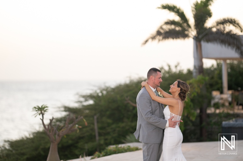 Romantic wedding couple at Coral Estate Luxury Resort in Curacao during sunset overlooking the ocean