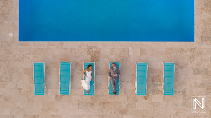 Couple relaxes by the poolside at Coral Estate Luxury Resort in Curacao during their wedding celebration