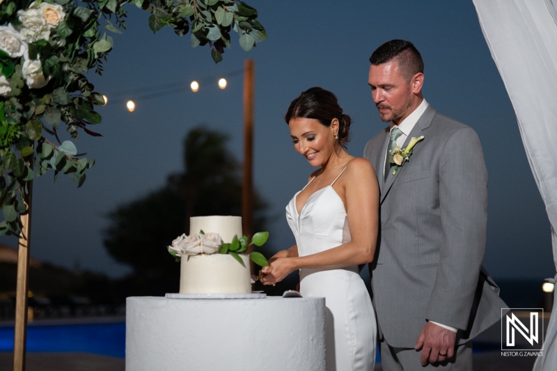 Celebrating love with a cake cutting ceremony at Coral Estate Luxury Resort in Curacao at dusk