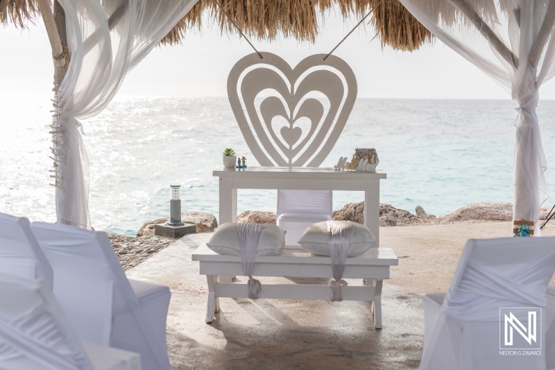 Wedding setup at Karakter in Curacao with ocean backdrop and heart-shaped decor