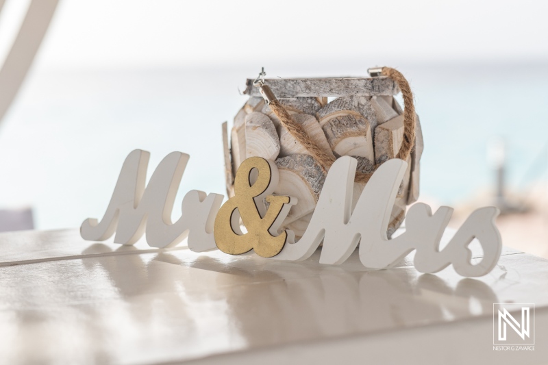 Elegant wedding decoration at Karakter in Curacao featuring Mr and Mrs sign with a beautiful ocean backdrop