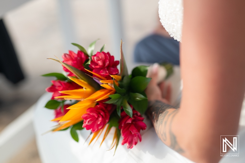 Couple's romantic wedding celebration in Curacao with vibrant bouquet of tropical flowers