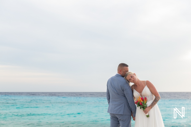 Couple celebrates their wedding at Karakter Curacao with a romantic waterfront backdrop during a soft sunset