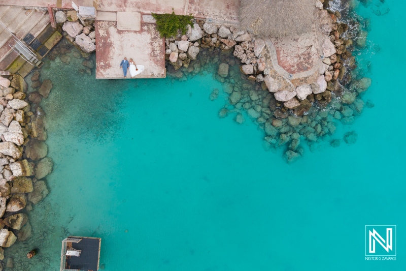 Stunning wedding ceremony at Karakter beach in Curacao with crystal-clear waters and natural beauty surrounding the couple