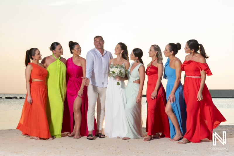 A joyful beach wedding celebration with a bride and her friends in colorful dresses at sunset in a tropical paradise