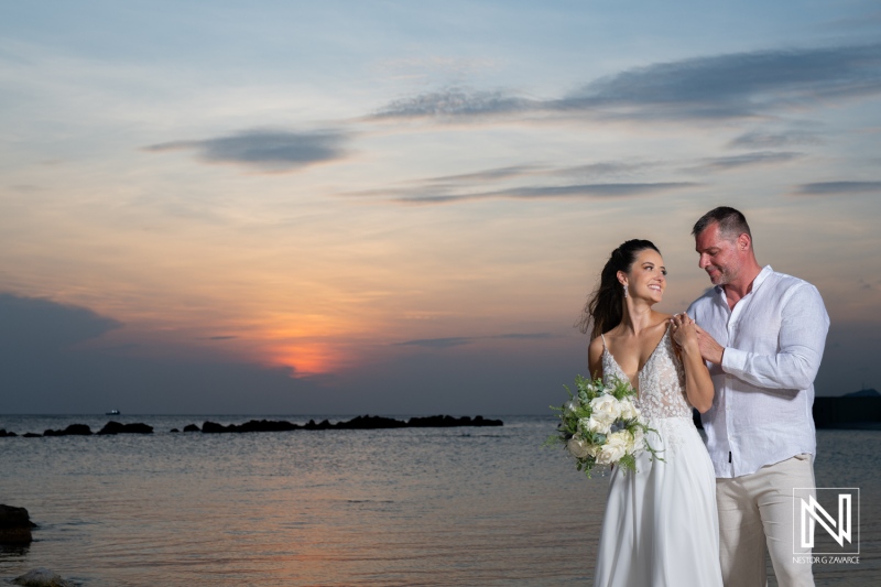 A romantic beach wedding at sunset with a couple celebrating their love surrounded by serene waves and beautiful skies in a picturesque setting