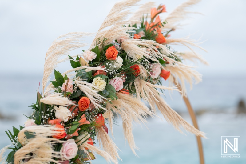 Beautiful floral arch at a destination wedding in Sunscape Curacao by the ocean