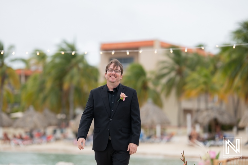 Groom walks confidently toward the ceremony at Sunscape Curacao destination wedding