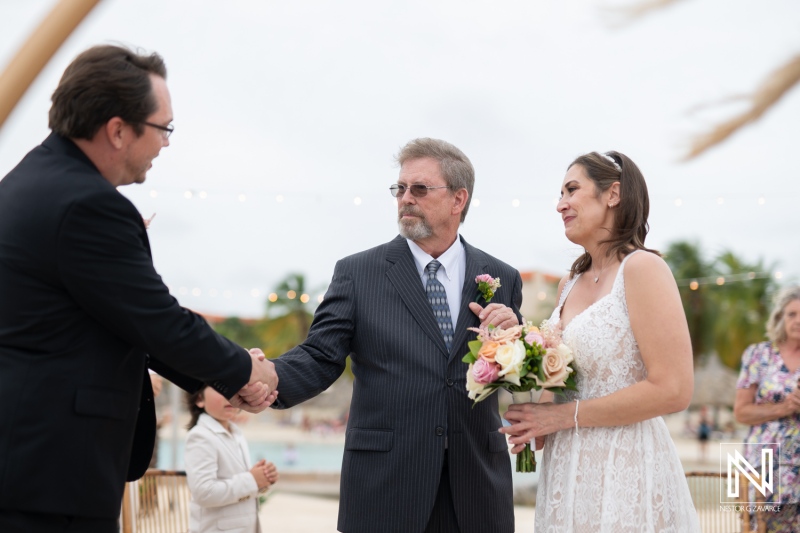 Couple exchanges vows during a romantic destination wedding in Curacao at Sunscape Curacao
