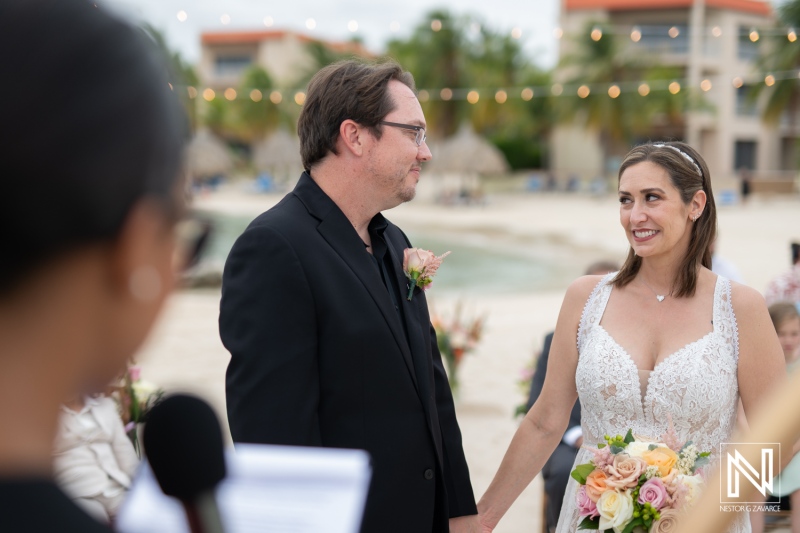 Couple exchanges vows during their destination wedding at Sunscape Curacao in a picturesque beach setting