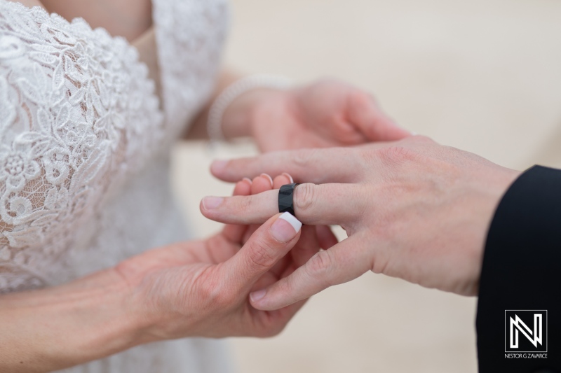 Couple exchanges wedding rings during a beautiful ceremony at Sunscape Curacao resort under the stunning Caribbean sky
